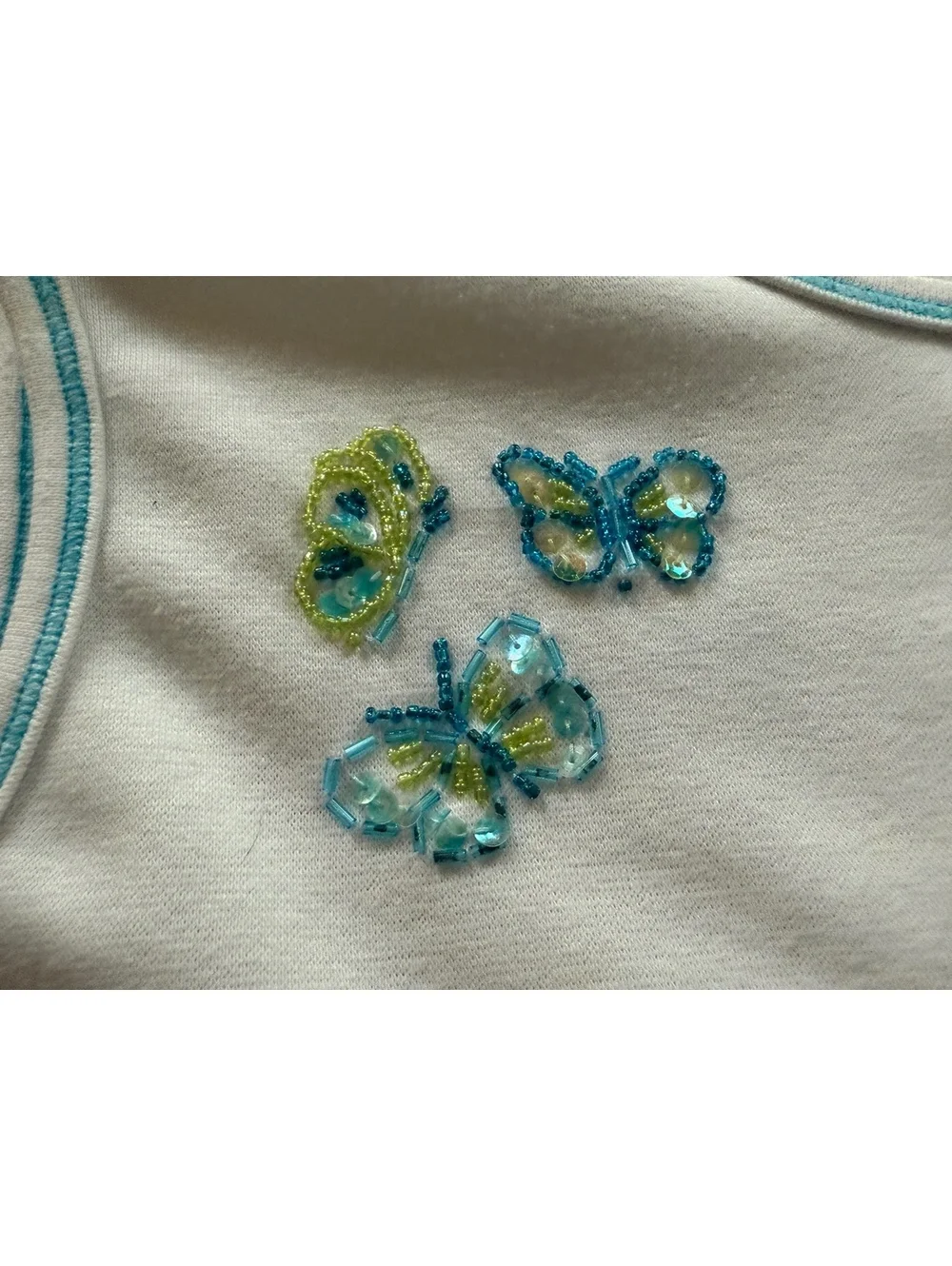 White Sleeveless Top with Beaded Butterfly Embellishments